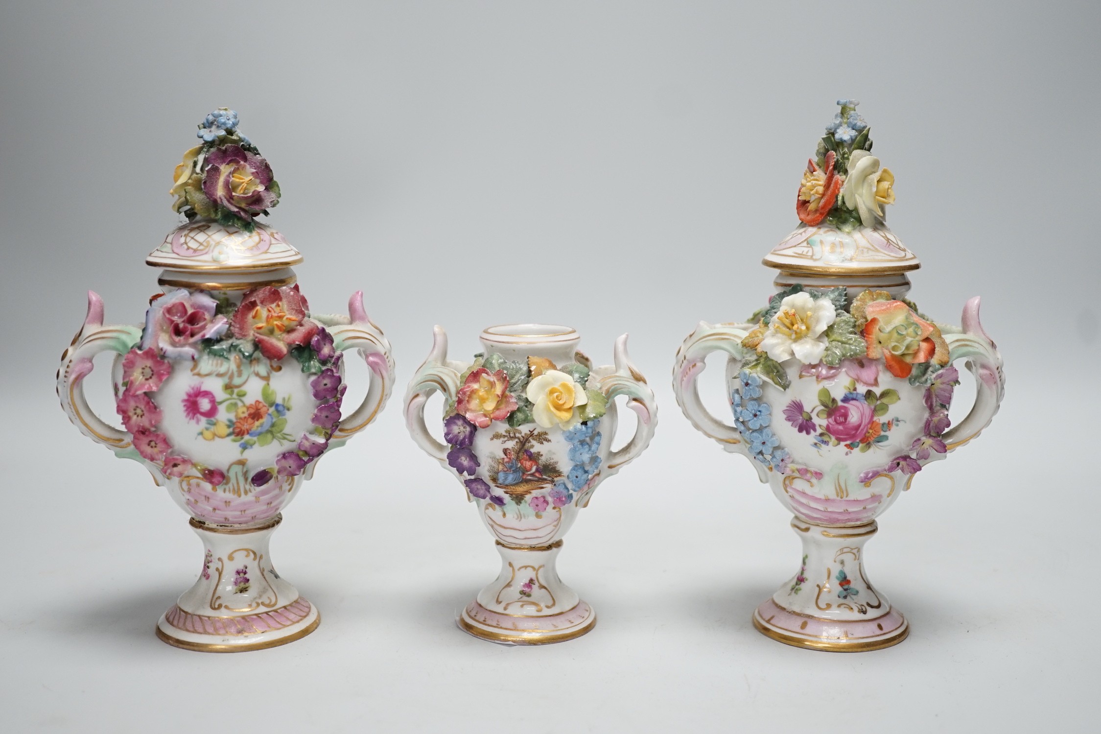 Three 19th century Dresden floral encrusted vases, two with covers, 16cm